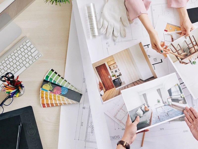 Group Of People Around A Table Charting Our Designs for a Home